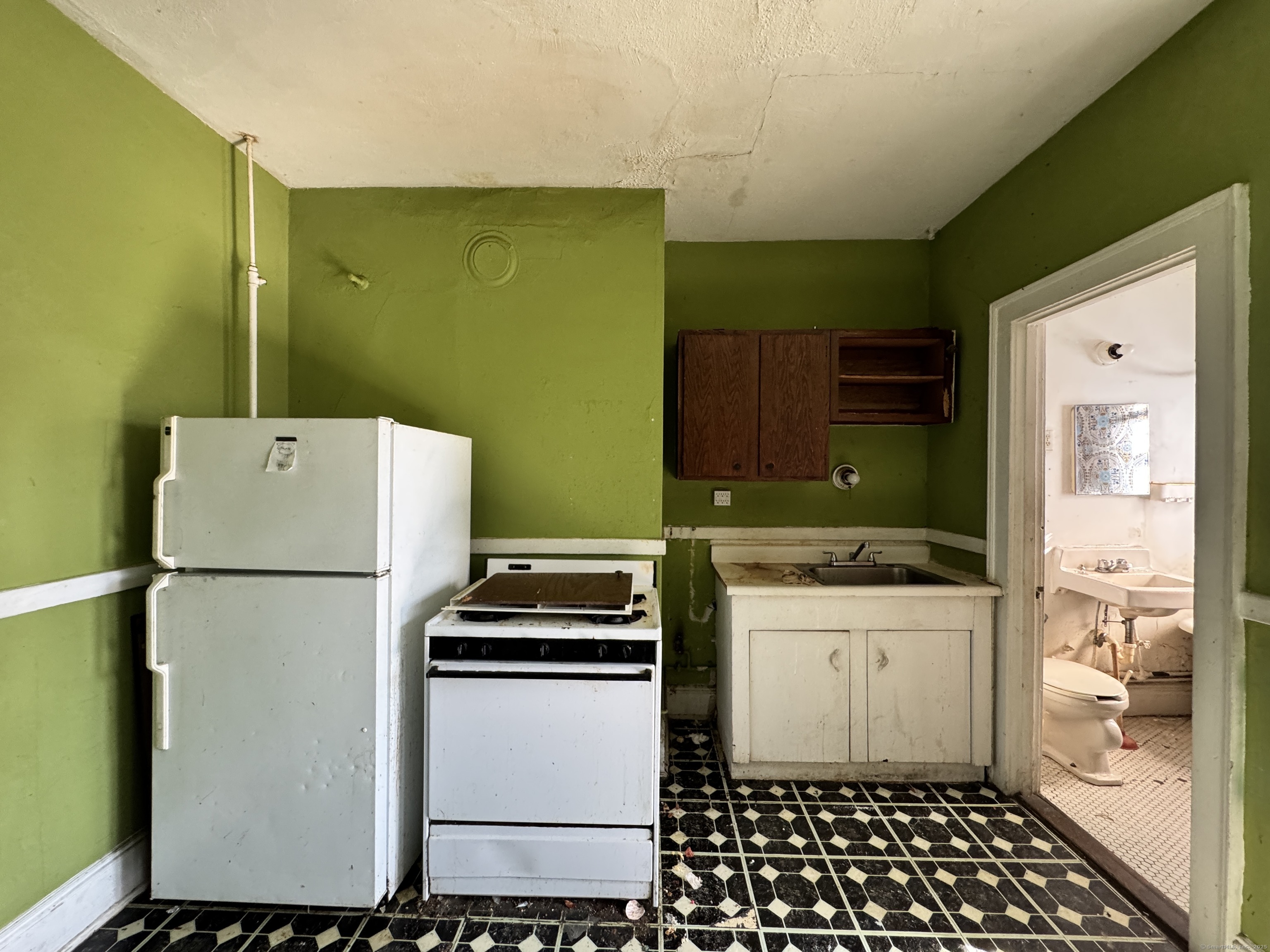 102 Rowe Avenue Hartford, CT 06106 - Photo 16 of 28 a kitchen with a refrigerator and a stove top oven