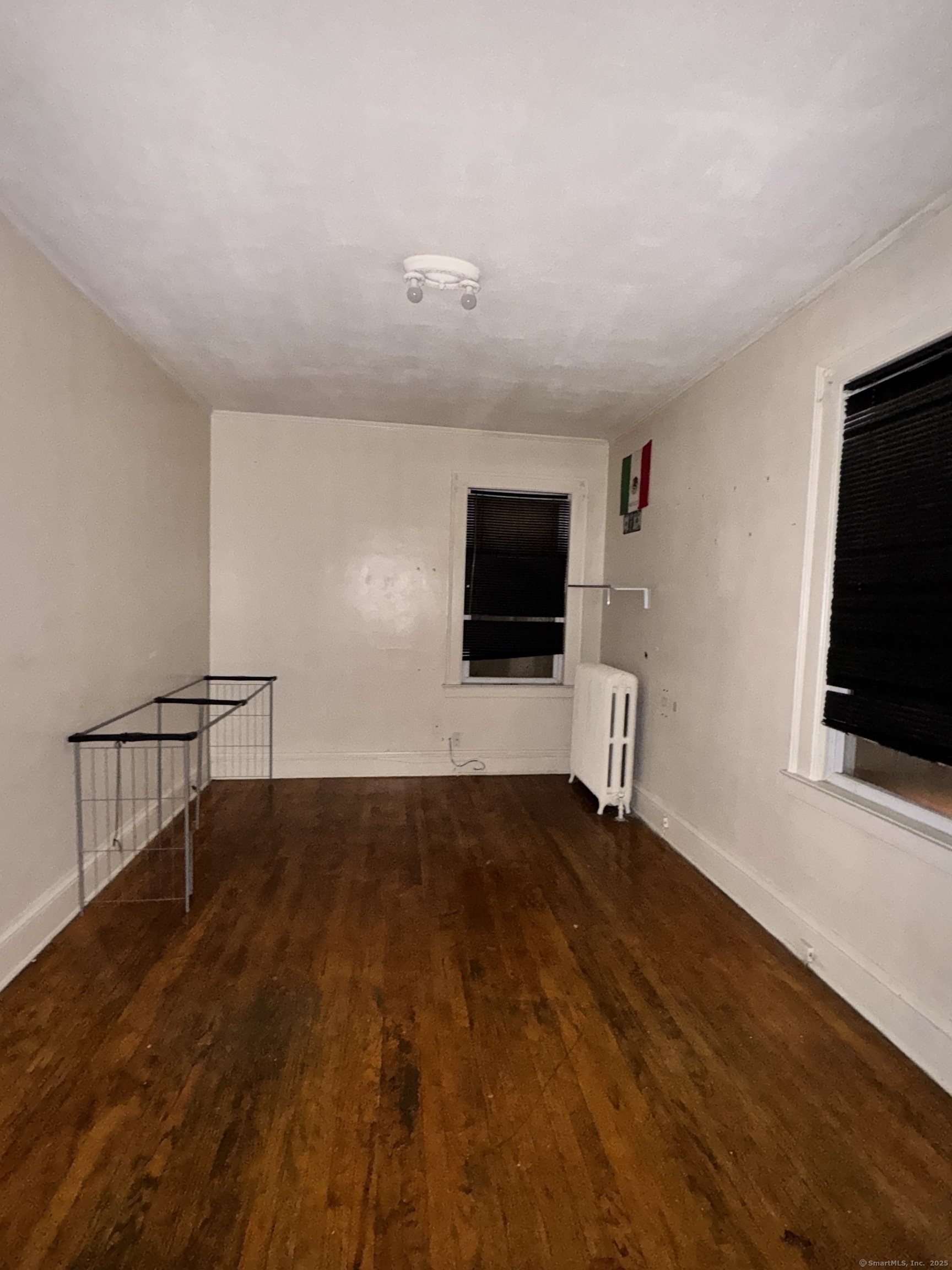 102 Rowe Avenue Hartford, CT 06106 - Photo 21 of 28 a view of an empty room with wooden floor and a window