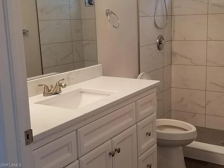 8208 Matanzas Road Fort Myers, FL 33967 - Photo 6 of 9 a bathroom with a sink a toilet and shower