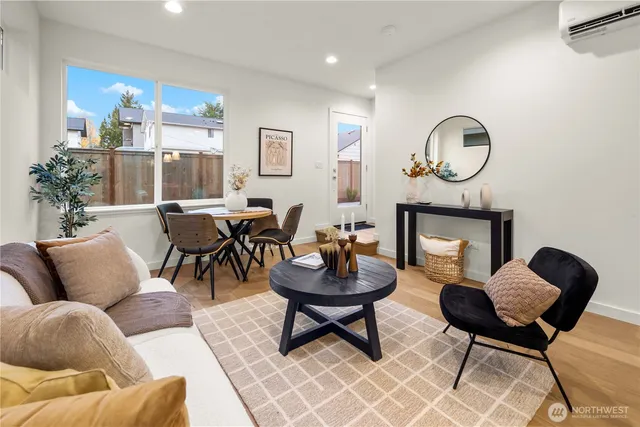 a living room with couches a mirror and a potted plant
