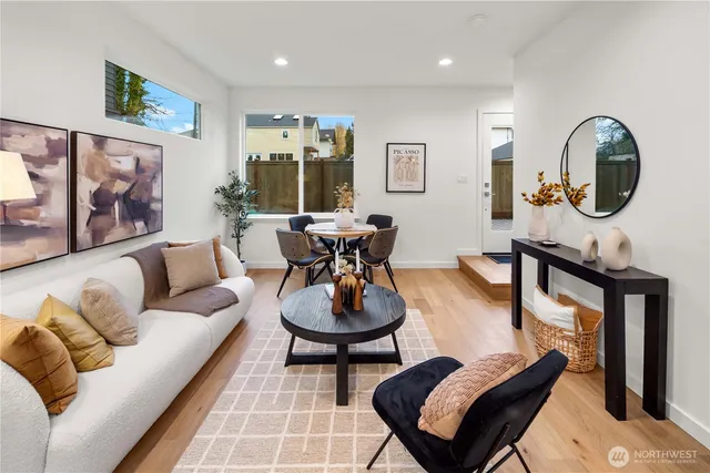 a living room with furniture a mirror and a lamp