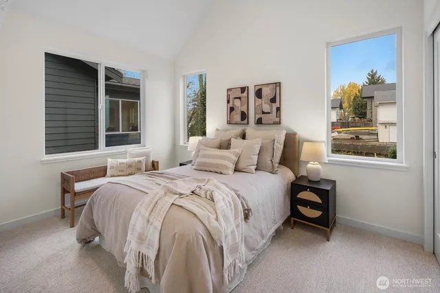 a bedroom with a bed and a painting on the wall