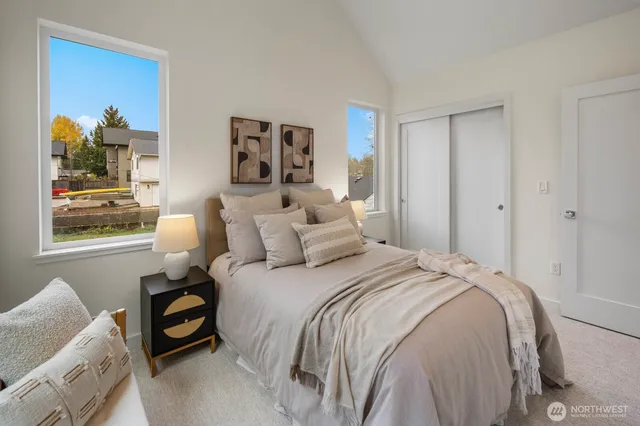 a bed sitting in a bedroom next to a bathroom