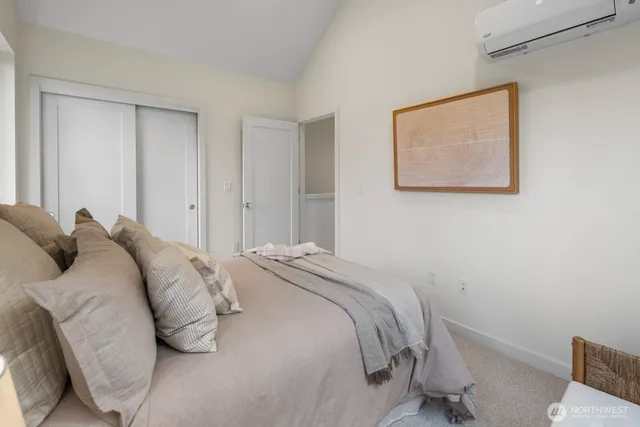 a bedroom with a bed and a painting on the wall