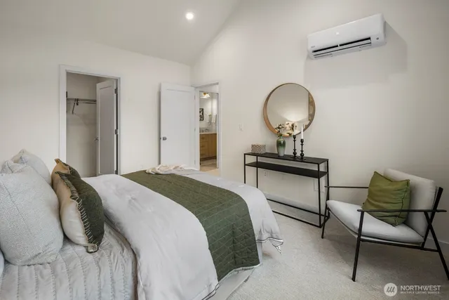 a bedroom with a bed and a lamp with the potted plant