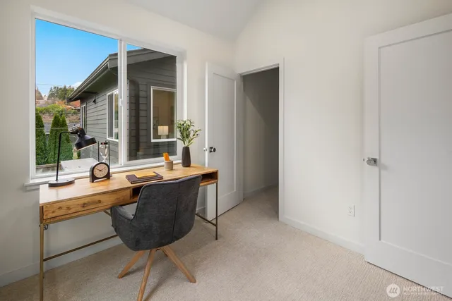 a view of a workspace with a window and sitting area