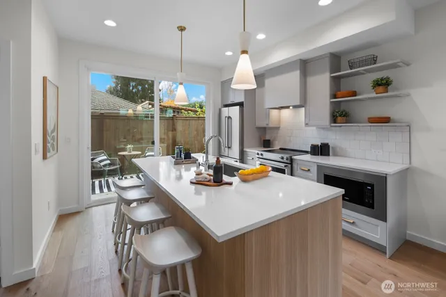a kitchen with a table chairs stove and microwave
