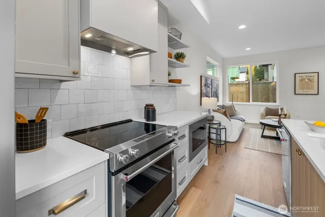 a kitchen with a stove and a wooden floors