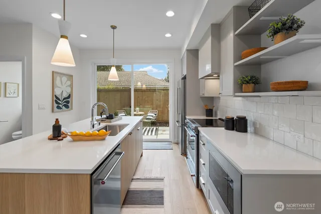 a kitchen with a sink a stove and chairs
