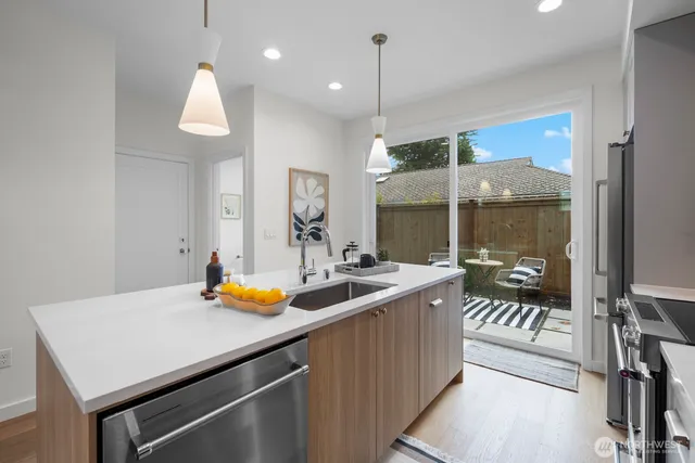 a kitchen with a sink a counter and chairs