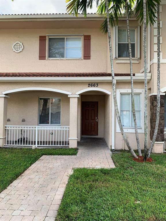 2663 Southwest 82nd Avenue, Unit 104 Miramar, FL 33025 - Photo 1 of 28 a view of a house with a yard and a large tree