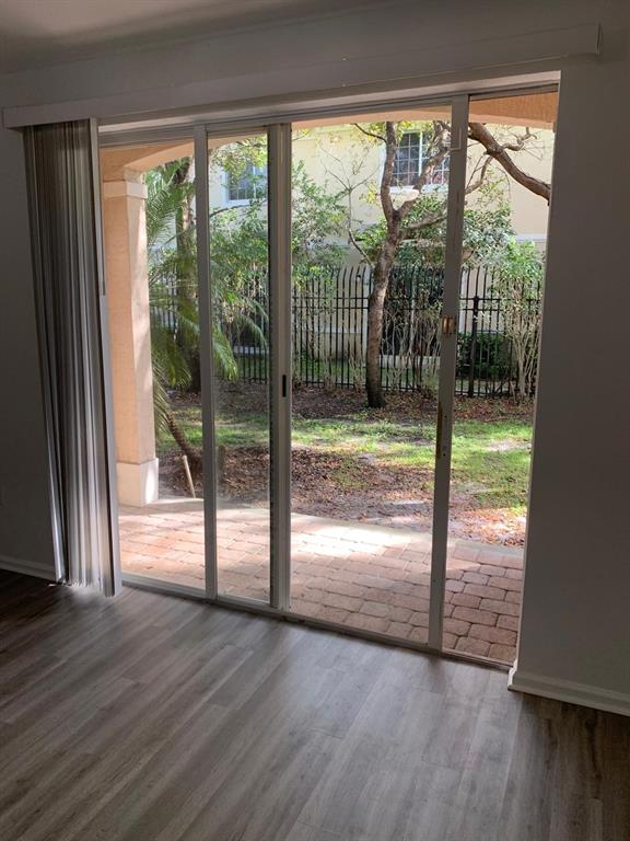 2663 Southwest 82nd Avenue, Unit 104 Miramar, FL 33025 - Photo 14 of 28 a view of empty room with wooden floor and floor to ceiling window