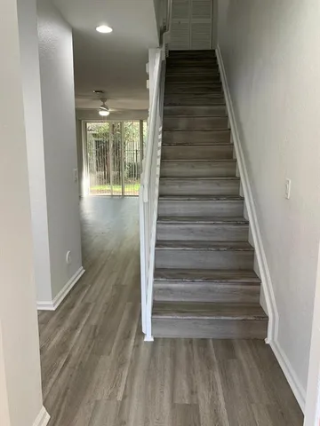a view of entryway and hall with wooden floor