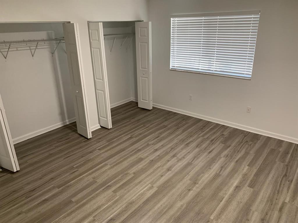 2663 Southwest 82nd Avenue, Unit 104 Miramar, FL 33025 - Photo 21 of 28 an empty room with wooden floor and a window