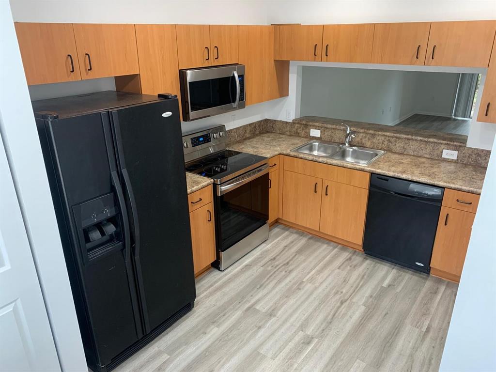 2663 Southwest 82nd Avenue, Unit 104 Miramar, FL 33025 - Photo 25 of 28 a kitchen with stainless steel appliances granite countertop a refrigerator and a stove top oven