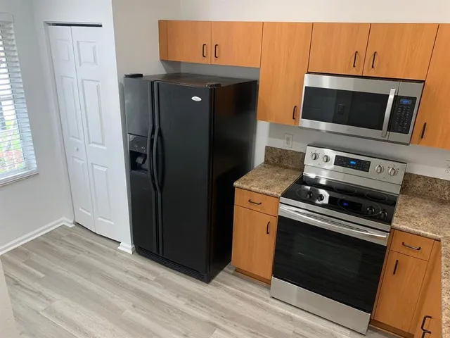 a kitchen with a stove microwave and refrigerator