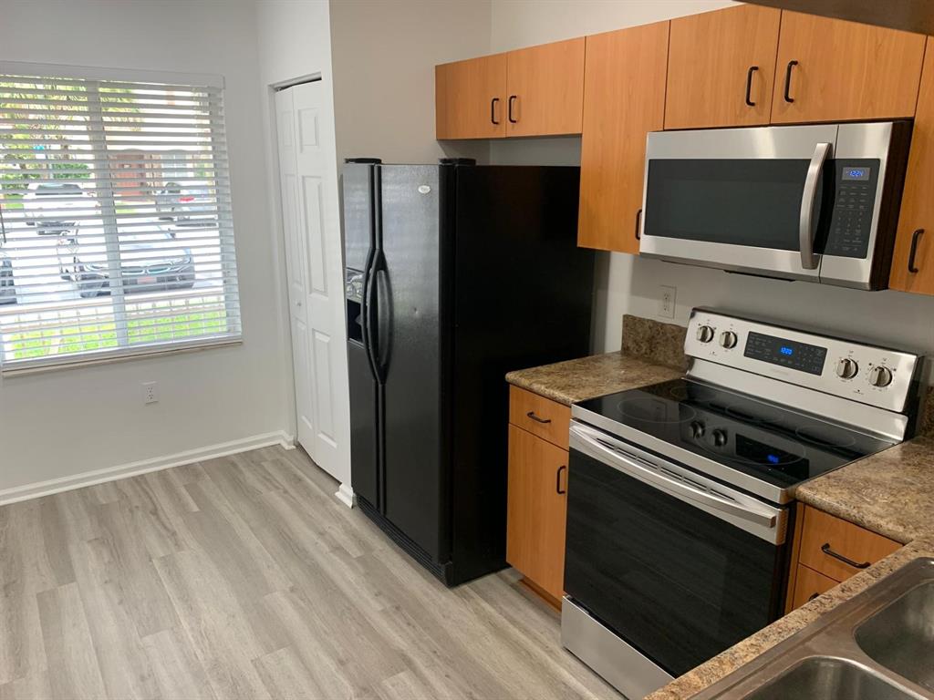 2663 Southwest 82nd Avenue, Unit 104 Miramar, FL 33025 - Photo 27 of 28 a kitchen with a stove microwave and refrigerator