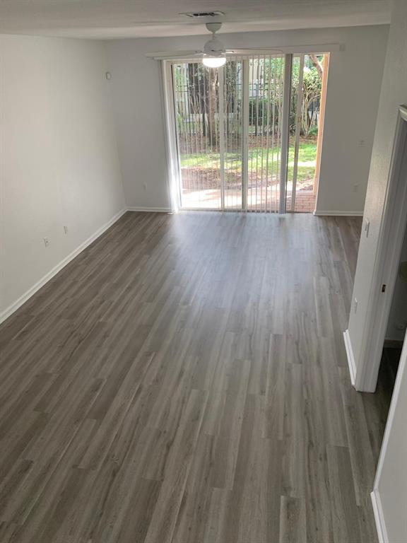 2663 Southwest 82nd Avenue, Unit 104 Miramar, FL 33025 - Photo 4 of 28 a view of an empty room with wooden floor and a window