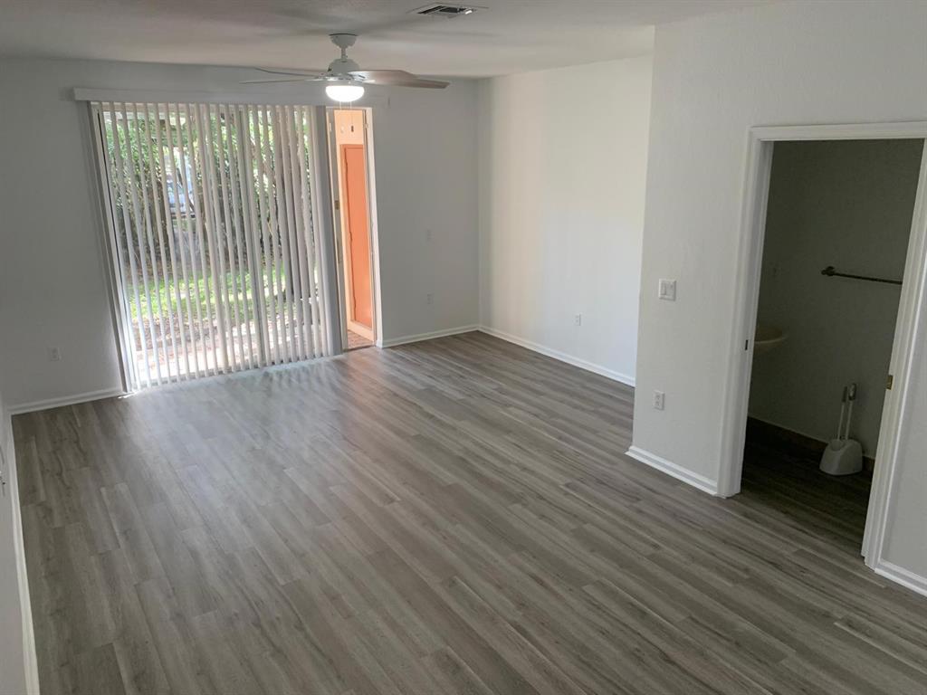 2663 Southwest 82nd Avenue, Unit 104 Miramar, FL 33025 - Photo 6 of 28 an empty room with wooden floor and windows