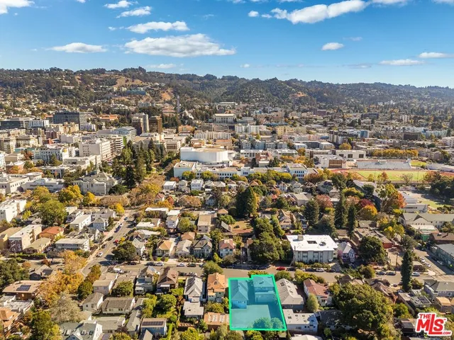 an aerial view of residential houses with city view