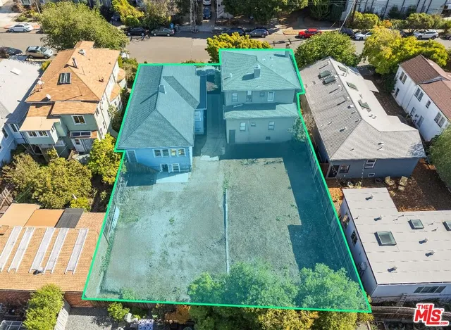 an aerial view of a house with a yard swimming pool and outdoor seating