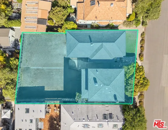 an aerial view of a house with a yard