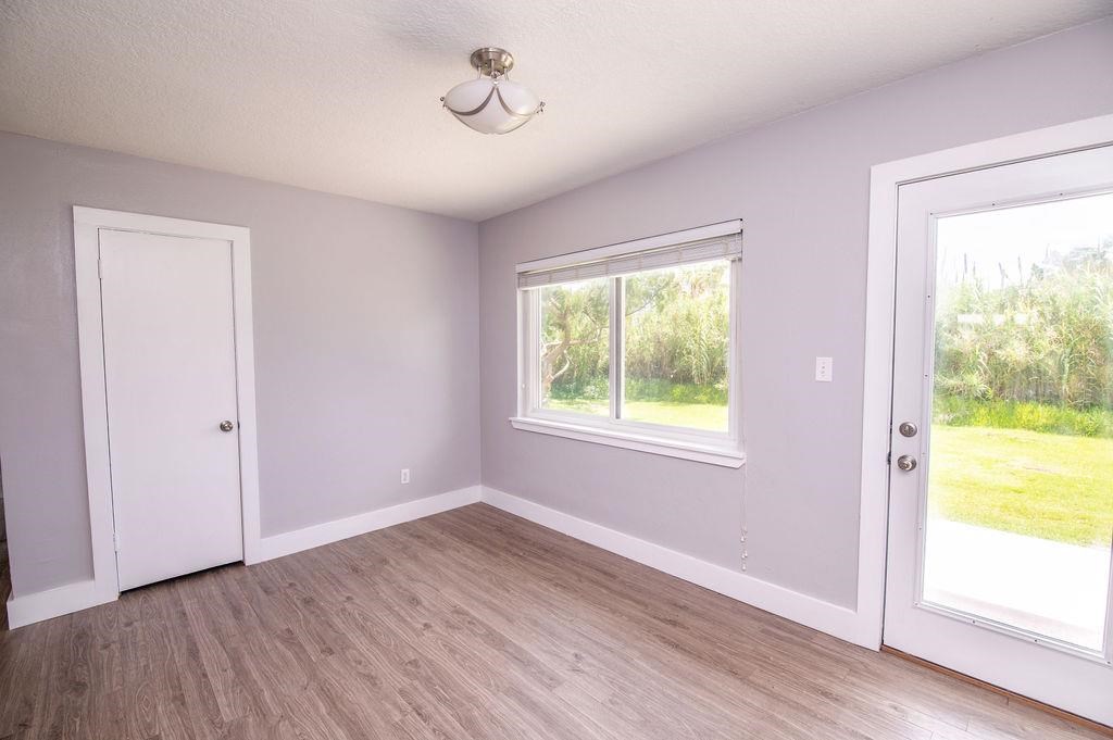 118 Menendez Road St. Augustine, FL 32080 - Photo 12 of 31 a view of an empty room with wooden floor and a window