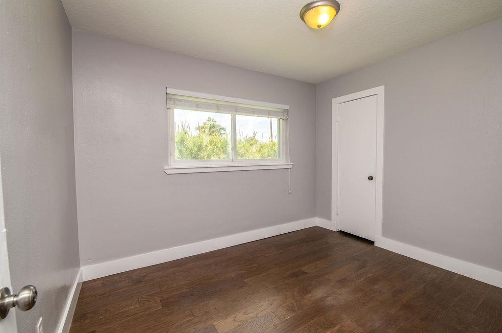 118 Menendez Road St. Augustine, FL 32080 - Photo 16 of 31 an empty room with window and wooden floor