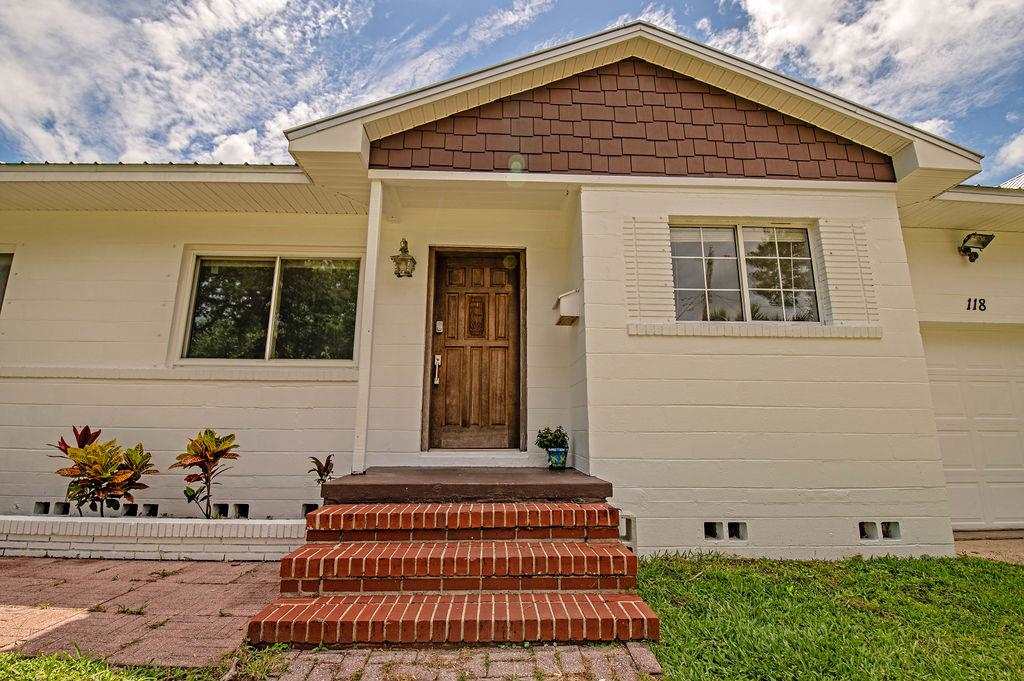 118 Menendez Road St. Augustine, FL 32080 - Photo 3 of 31 a front view of a house with a garden