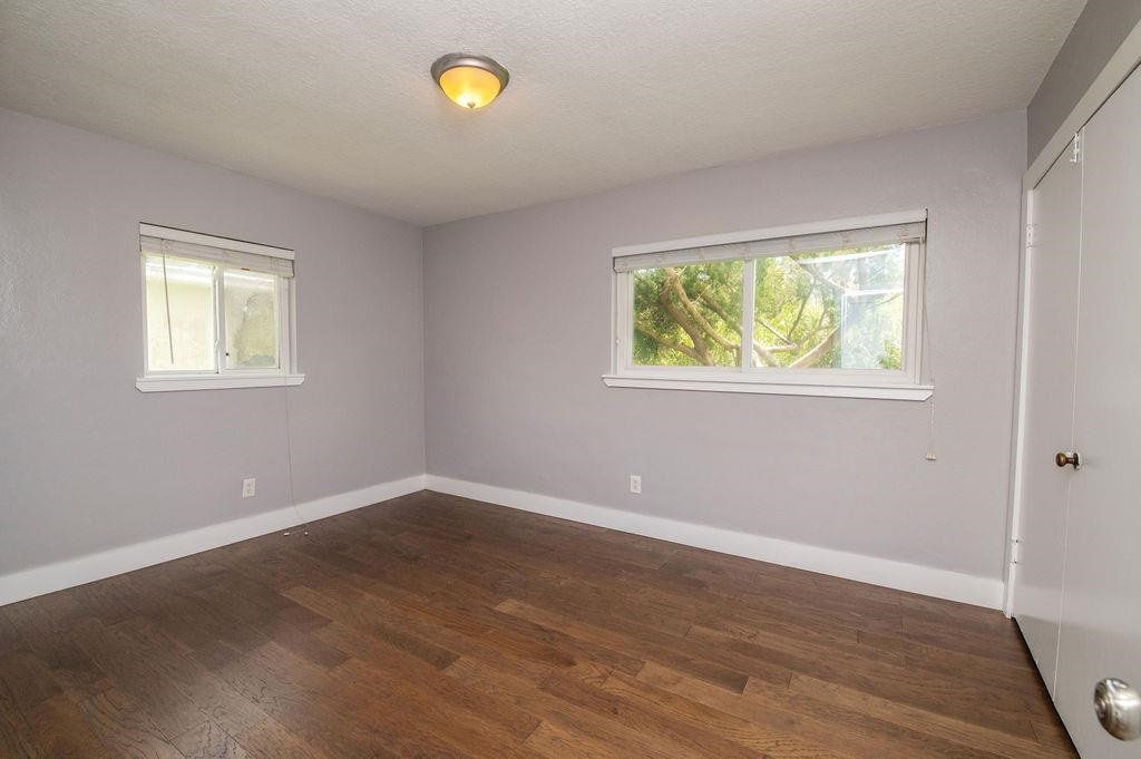 118 Menendez Road St. Augustine, FL 32080 - Photo 22 of 31 a view of an empty room with wooden floor and a window