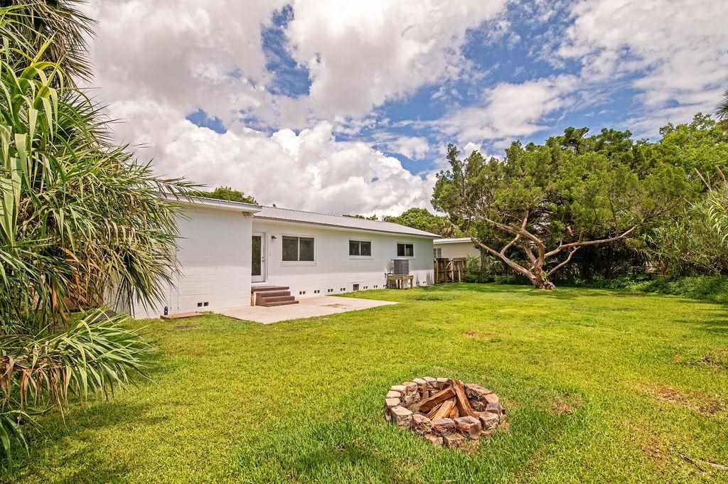 118 Menendez Road St. Augustine, FL 32080 - Photo 27 of 31 a front view of a house with garden