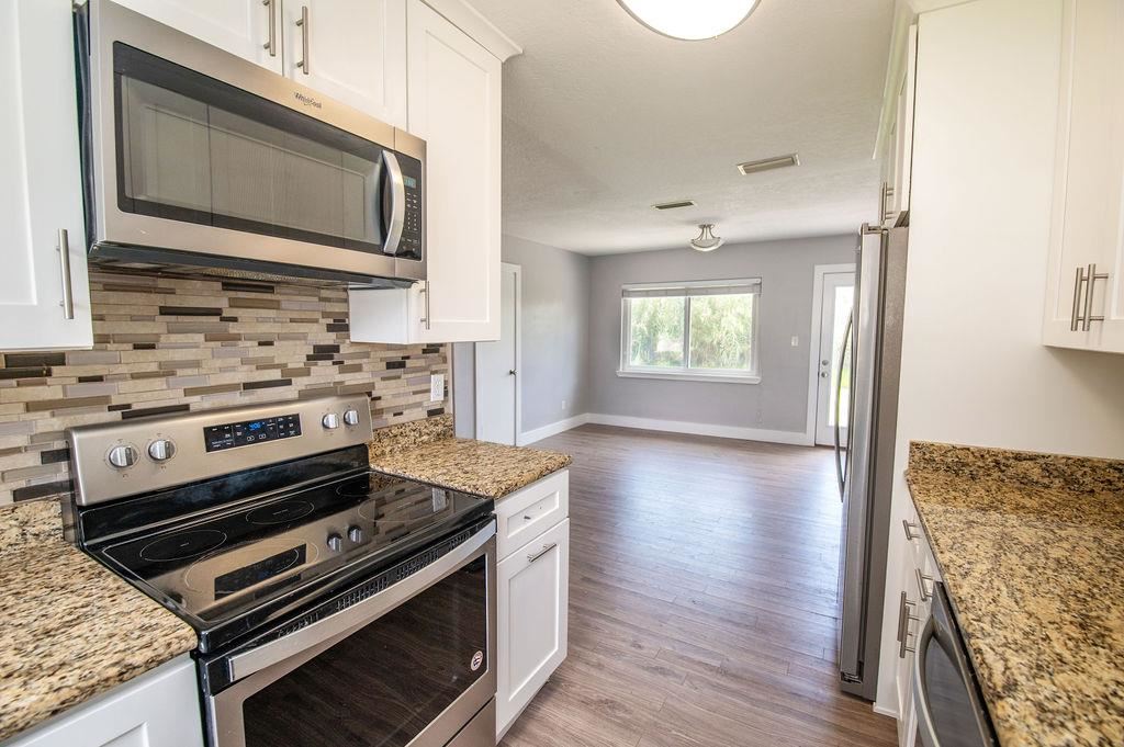 118 Menendez Road St. Augustine, FL 32080 - Photo 6 of 31 a kitchen with a stove and a microwave