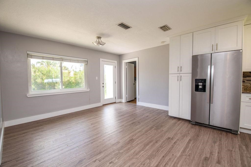 118 Menendez Road St. Augustine, FL 32080 - Photo 8 of 31 a view of an empty room with wooden floor and a window