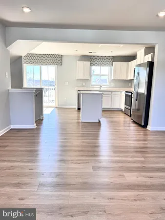 a room with wooden floors and windows