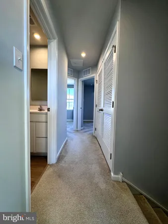 a view of a hallway with a kitchen