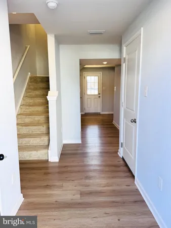 a view of an entryway with wooden floor