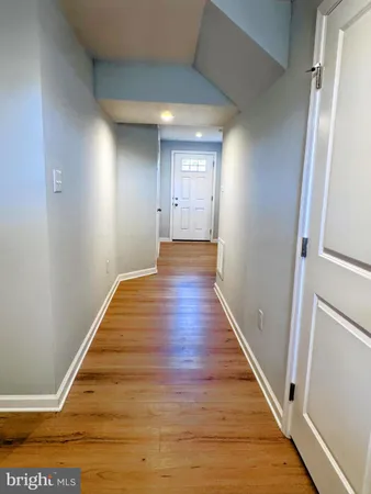 a view of a hallway with wooden floor