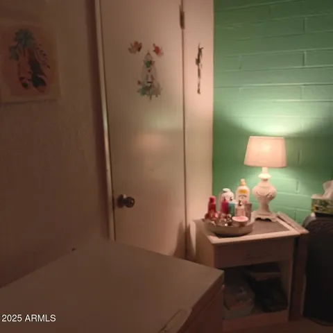 a bedroom with a bed a dresser and a chair