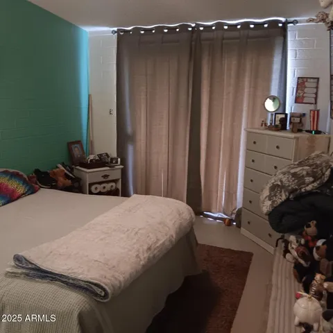 a bedroom with a bed and green walls