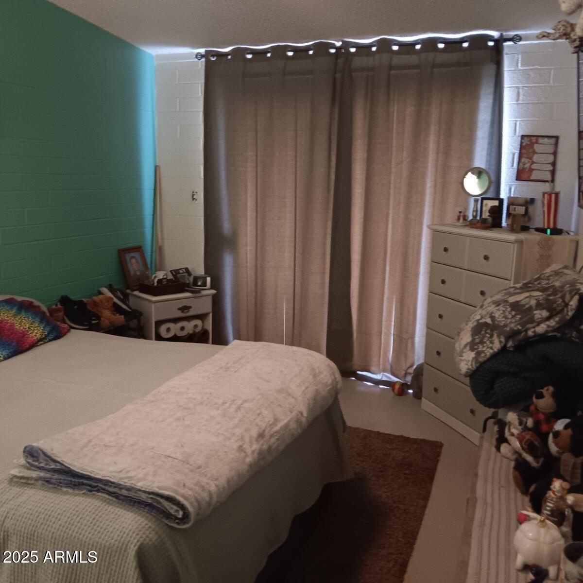 719 North Cherry Mesa, AZ 85201 - Photo 17 of 18 a bedroom with a bed a dresser and a chair