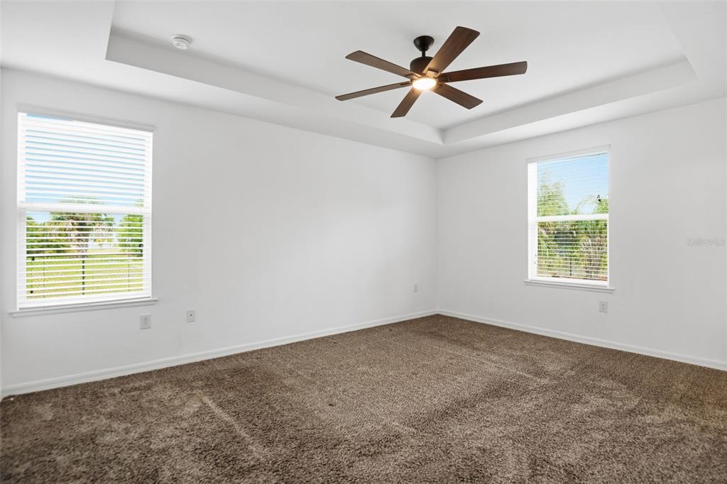 4322 Kiska Road North Port, FL 34288 - Photo 15 of 37 a view of a big room with wooden floor and a ceiling fan
