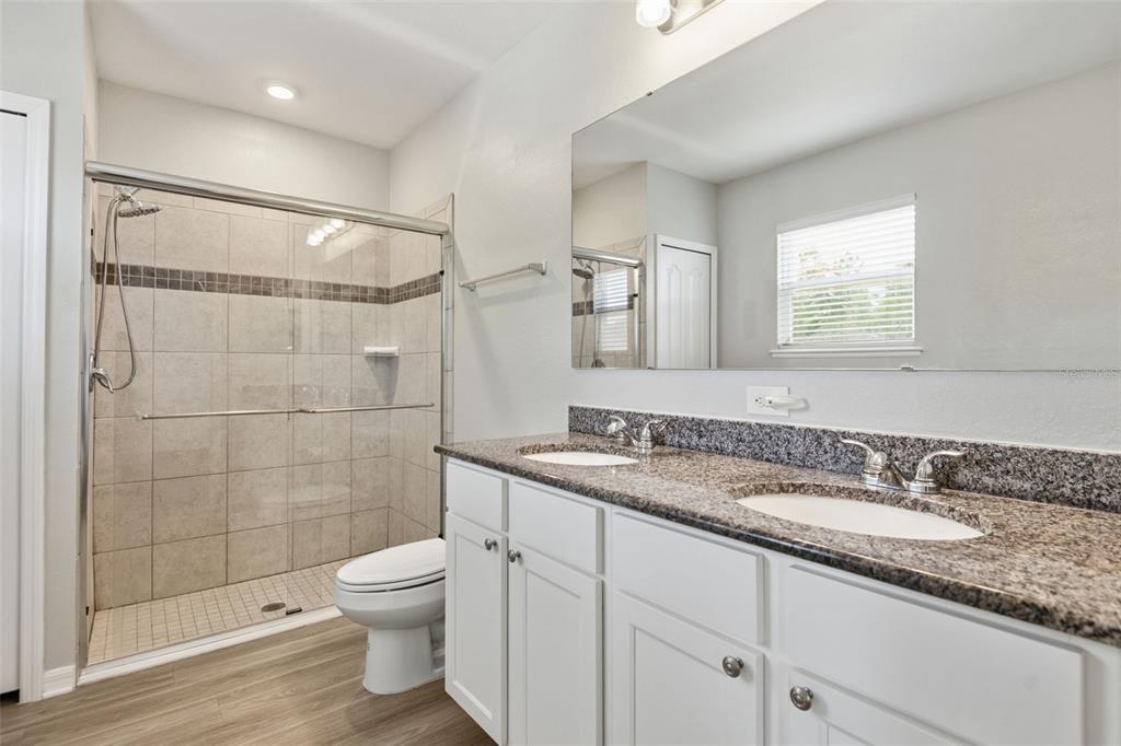 4322 Kiska Road North Port, FL 34288 - Photo 17 of 37 a bathroom with a granite countertop sink a toilet and shower