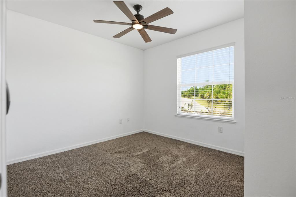 4322 Kiska Road North Port, FL 34288 - Photo 19 of 37 an empty room with a window and a fan