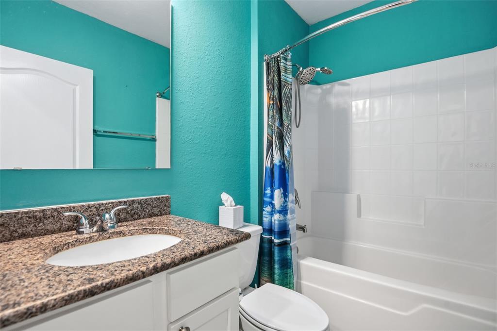 4322 Kiska Road North Port, FL 34288 - Photo 21 of 37 a bathroom with a granite countertop sink toilet and shower