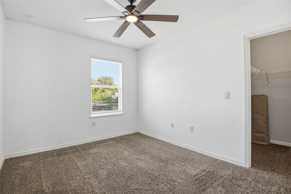 4322 Kiska Road North Port, FL 34288 - Photo 22 of 37 an empty room with a window and a fan