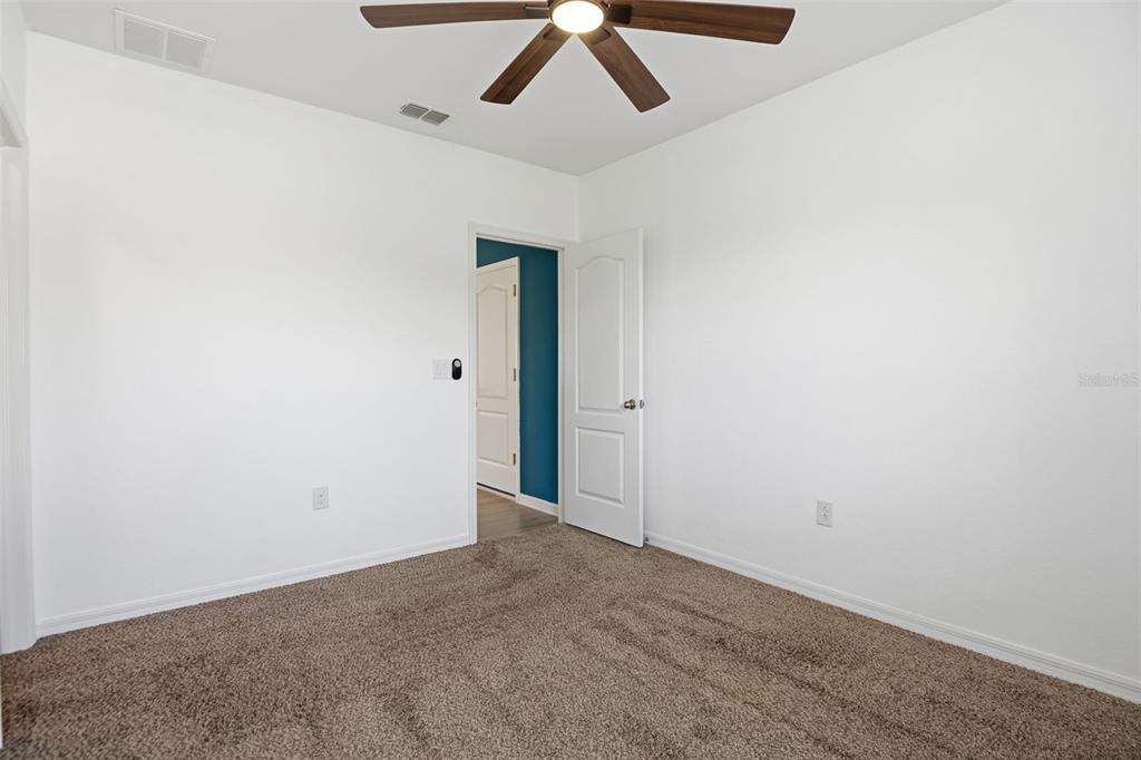 4322 Kiska Road North Port, FL 34288 - Photo 23 of 37 an empty room with a ceiling fan and wooden floor