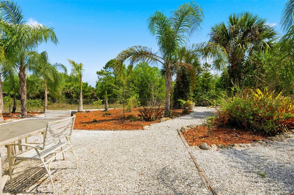 4322 Kiska Road North Port, FL 34288 - Photo 27 of 37 a view of a swimming pool with lounge chair and palm trees