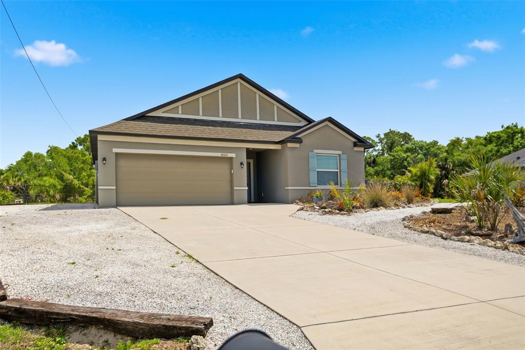4322 Kiska Road North Port, FL 34288 - Photo 3 of 37 a front view of a house with a yard