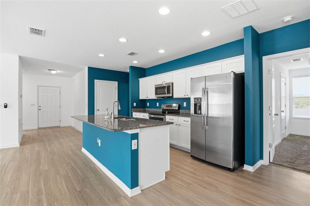 4322 Kiska Road North Port, FL 34288 - Photo 8 of 37 a kitchen with refrigerator and cabinets
