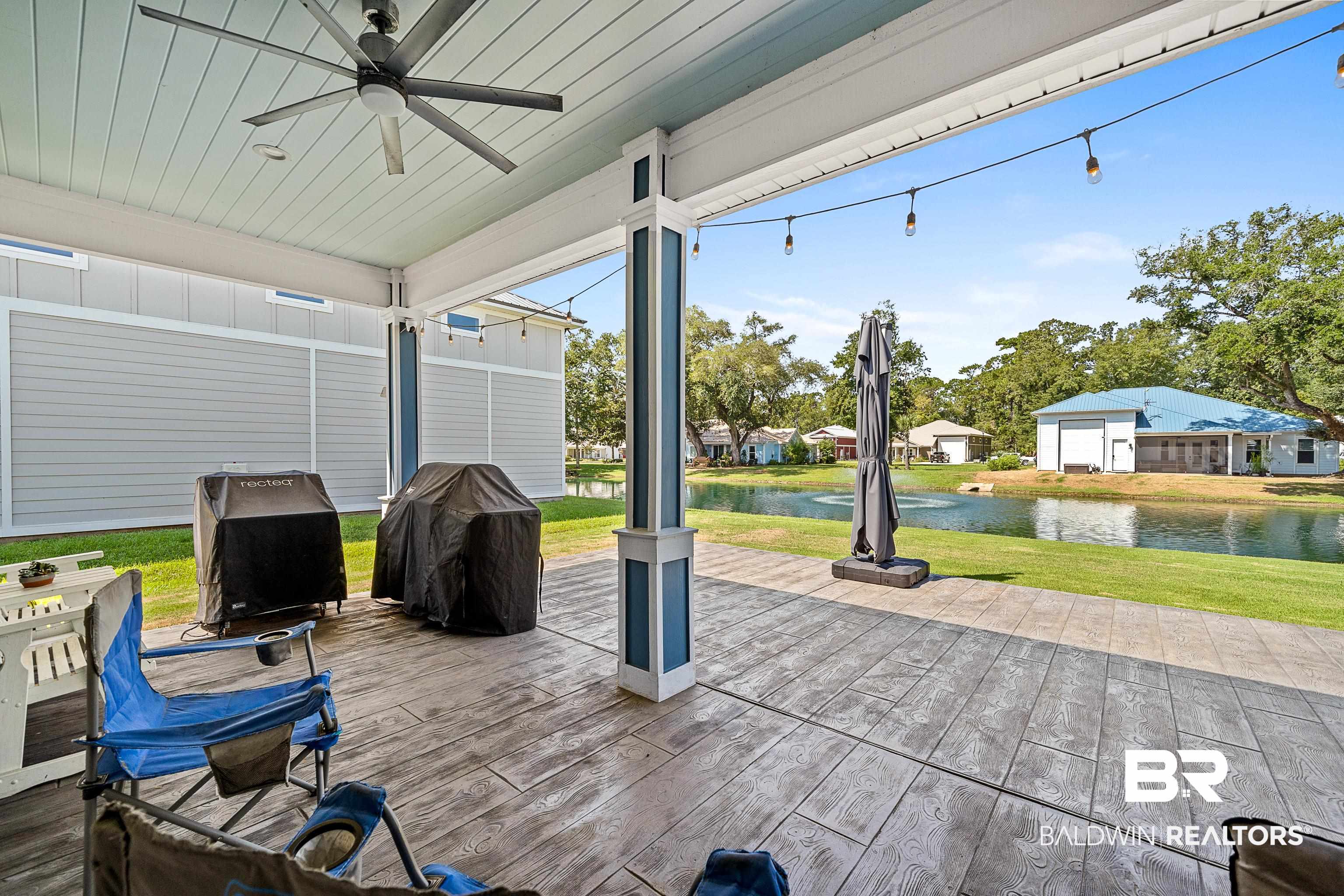 12329 Reunion Place, Unit LOT 38 Foley, AL 36535 - Photo 26 of 43 Wooden deck featuring a yard, a grill, a water view, and a ceiling fan